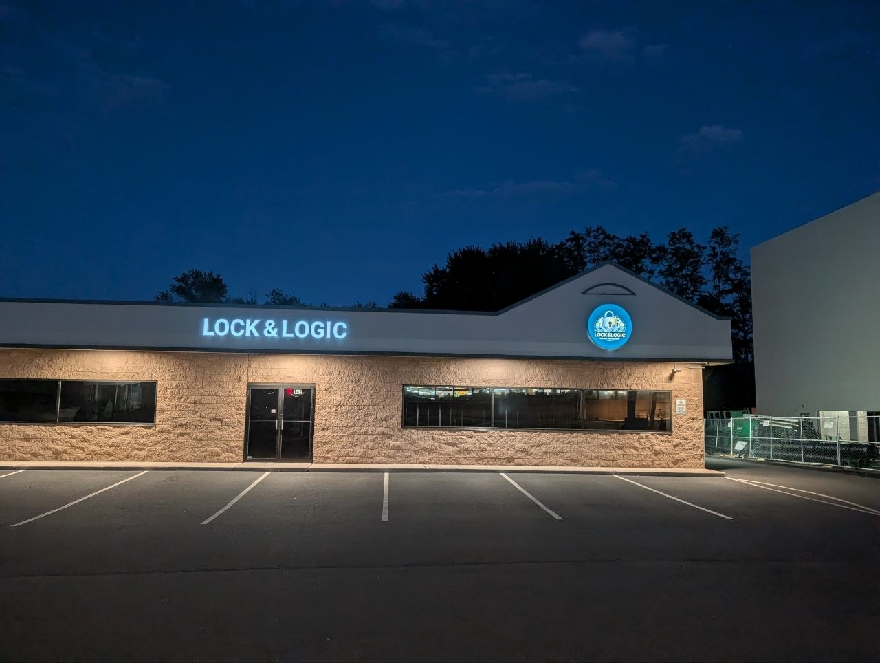 Lock & Logic building at night, sign lit up